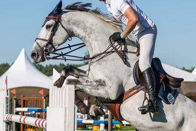 Low section of man riding horse