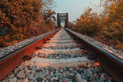 Railroad tracks with rocky tracks, looking far away to the evening sun.