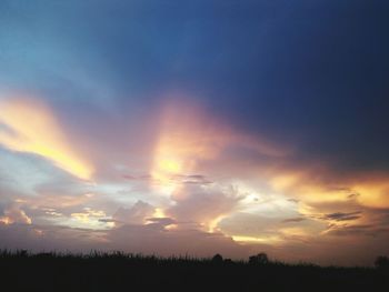 Scenic view of silhouette landscape against sky at sunset