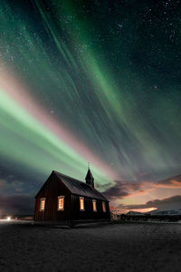 Illuminated building against sky at night