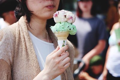 Midsection of woman holding ice cream