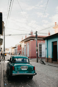 Car on street against buildings in city