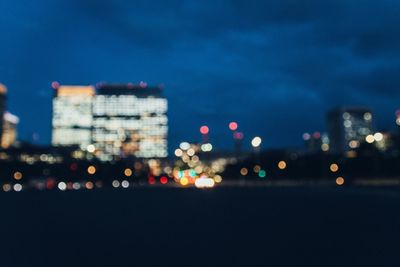 Close-up of illuminated city against sky at night