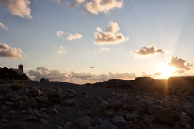 Scenic view of rocks against sky during sunset