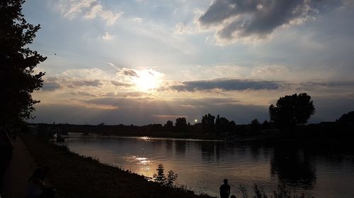 Scenic view of river against sky at sunset