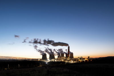 Uk, england, nottingham, water vapor rising from cooling towers of coal-fired power station at dusk