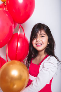 Portrait of a smiling girl with balloons