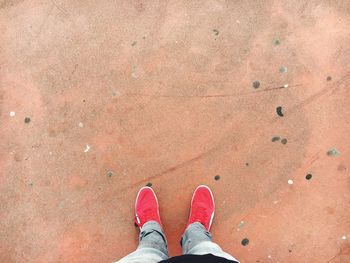 Low section of man standing on footpath