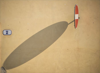 Shadow of no parking sign on wall