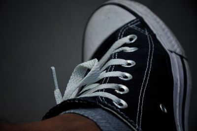 Low section of person wearing canvas shoes