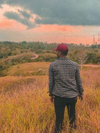 Rear view of man standing on field