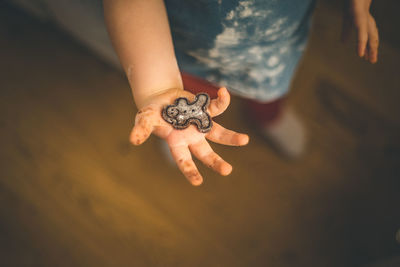 High angle view of child holding gingerbread cookie