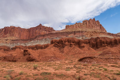 Capitol reef national park low angle landscape of pink, orange and purple barren stone hillside 