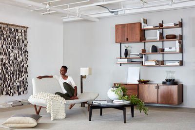 Woman lounging in modern livingroom setting