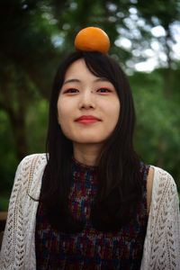 Portrait of beautiful woman against tree