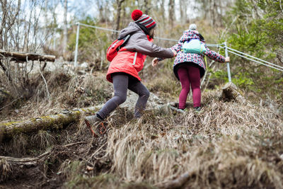 Rear view of women walking in forest