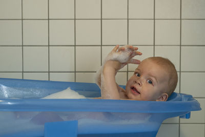 Portrait of cute baby in bathroom