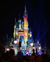 Illuminated clock tower at night
