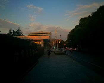 People on street in city at sunset