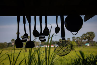 Low angle view of decorations hanging on field against sky