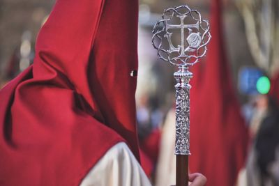 Man wearing costume during religious parade in city