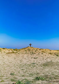 Man on field against clear sky