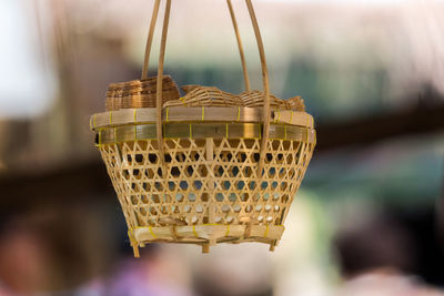 Close-up of basket making hanging outdoors