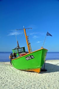 Boats in sea against blue sky
