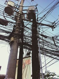 Low angle view of power lines against sky