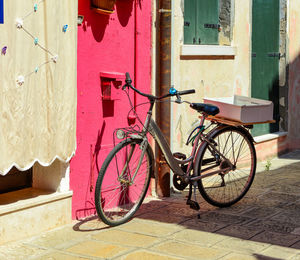 Bicycle parked against wall