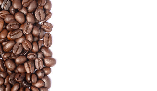 Close-up of coffee beans against white background