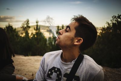 Close-up of boy wearing sunglasses against sky