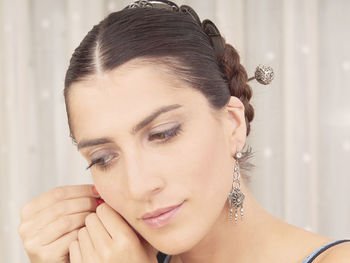 Close-up of young woman wearing earring