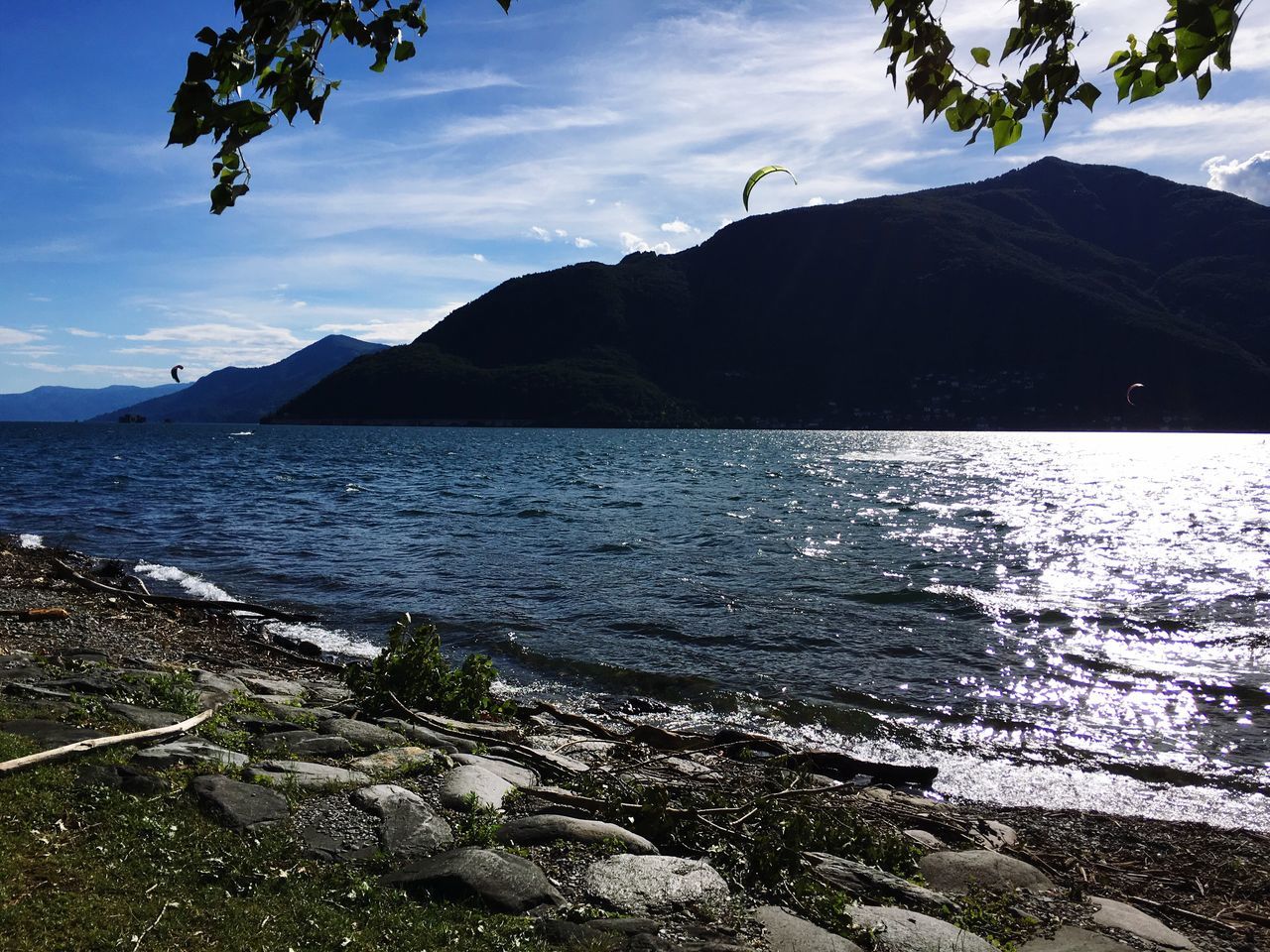 water, sea, nature, sky, tranquil scene, beauty in nature, cloud - sky, scenics, mountain, tranquility, rock - object, no people, outdoors, day, beach, horizon over water, tree