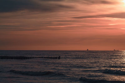 Scenic view of sea against orange sky