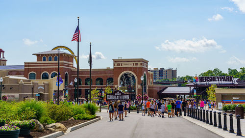 Group of people in front of buildings against sky