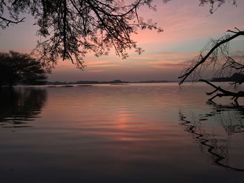 Scenic view of lake against sky at sunset
