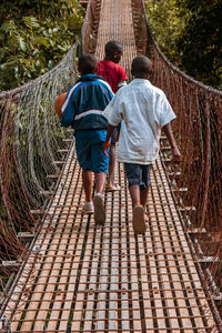 Rear view of people walking on footpath