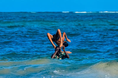 Boys playing in the sea