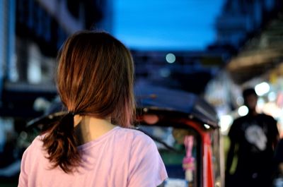 Rear view of woman standing in city