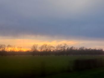 Scenic view of field against sky during sunset