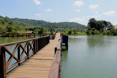 Pier over lake against sky
