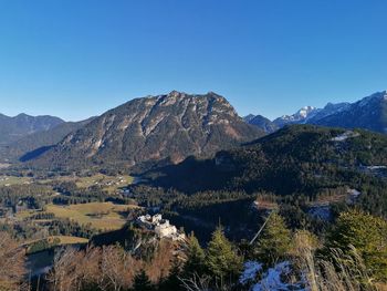 Scenic view of mountains against clear blue sky