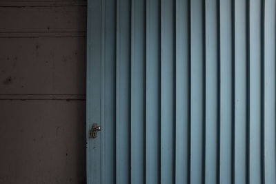 Blue metallic shutter by wall