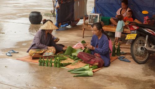 People working at market stall