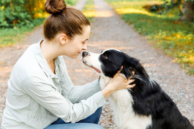 Portrait of dog sitting on field