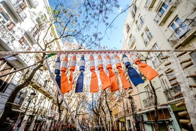 Low angle view of clothes hanging on building against sky