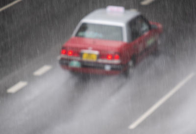 Blurred motion of car on street during rainy season