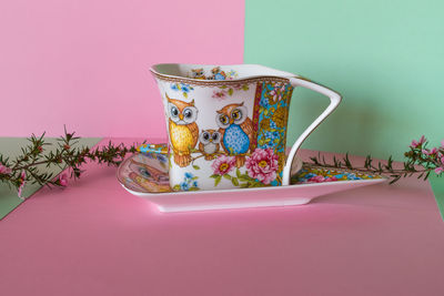 Close-up of pink tea cup on table