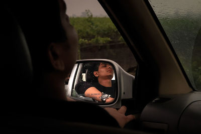 Portrait of man sitting in car